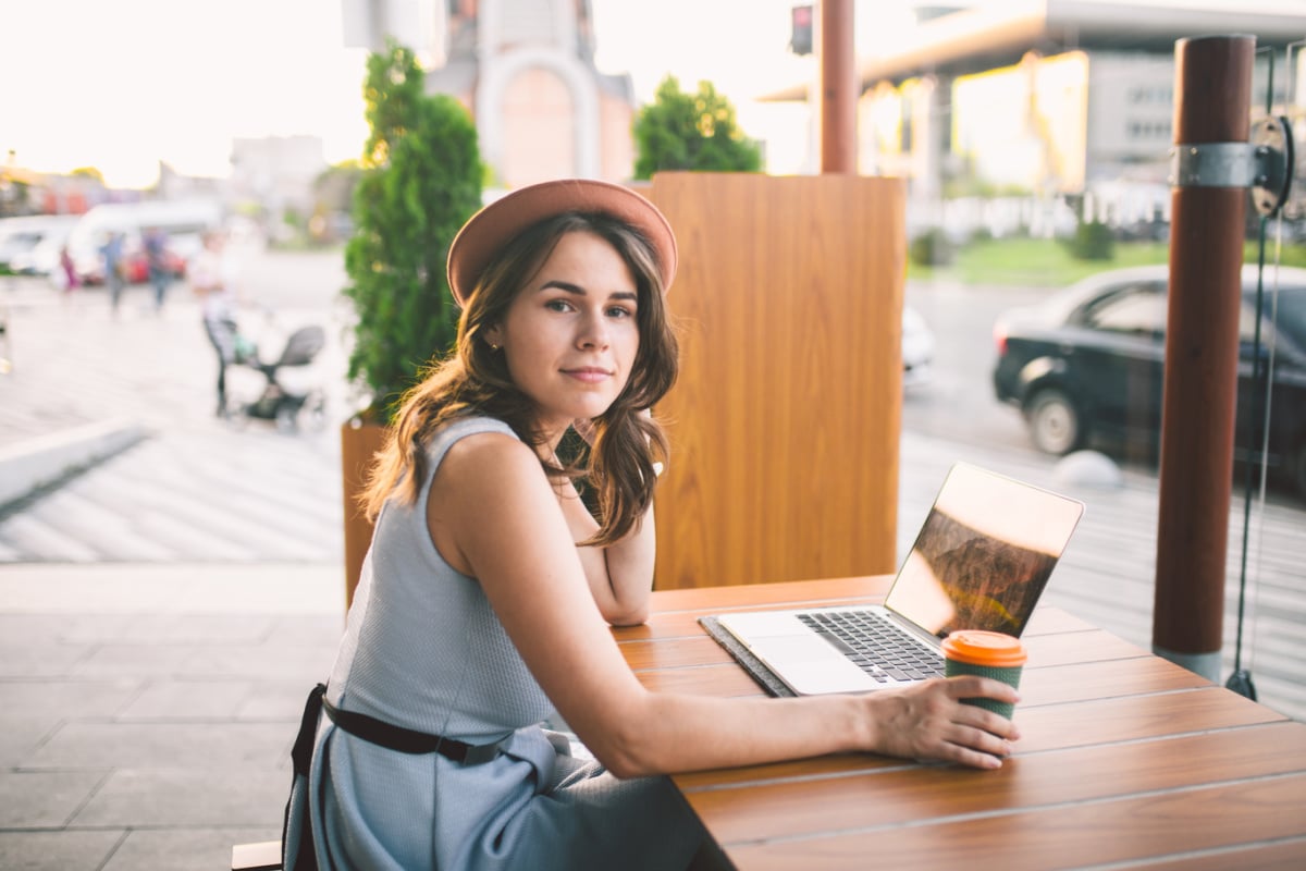 Female digital nomad with coffee at France cafe